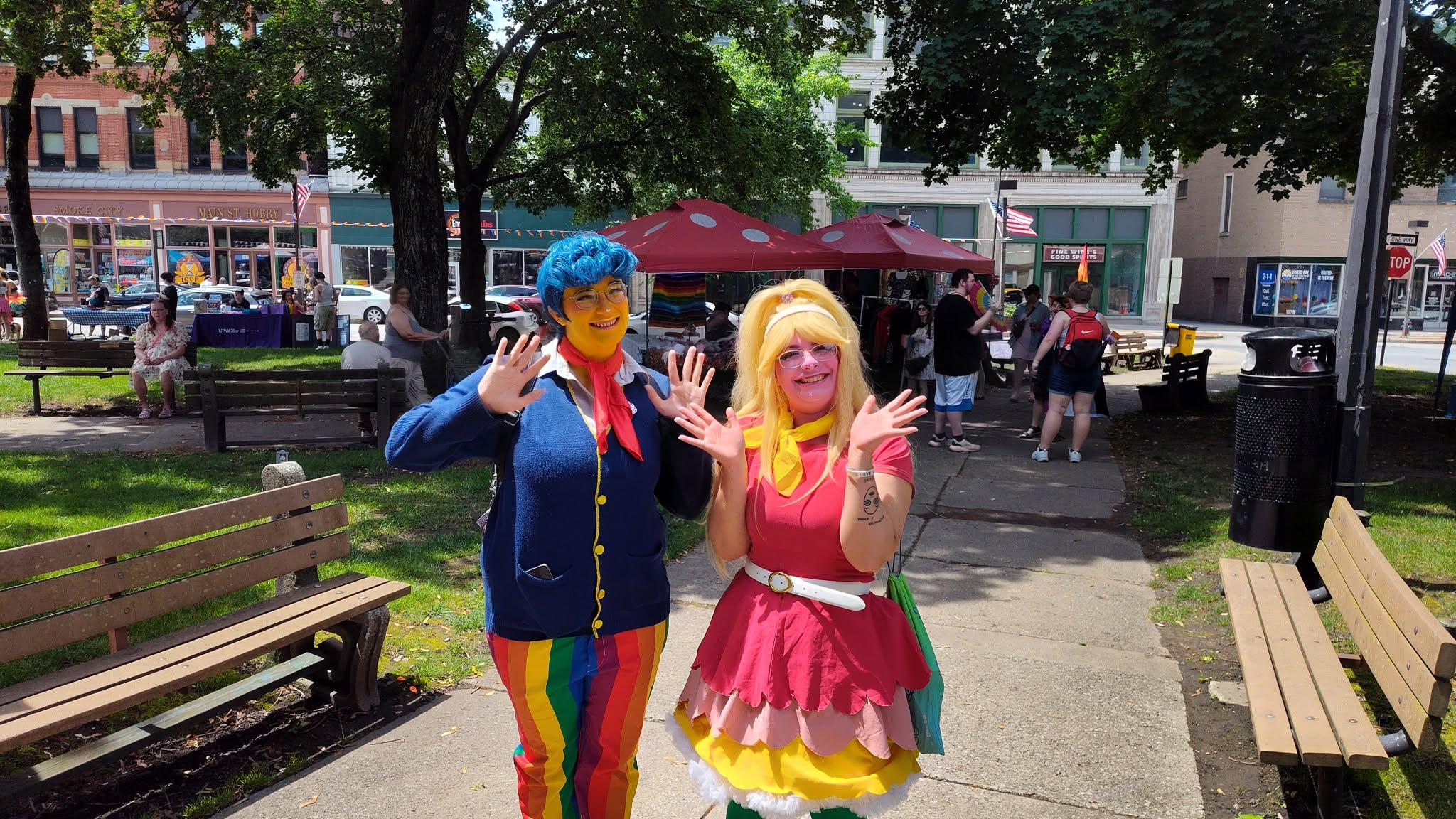 Colorfully costumed participants pose and wave during Johnstown Pride in downtown Johnstown, Pennsylvania